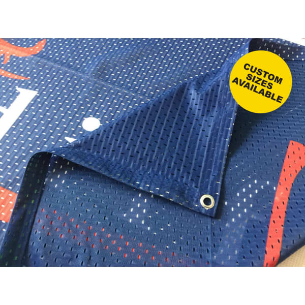 A blue mesh banner with perforated detailing and grommets for hanging, featuring a logo in the design.