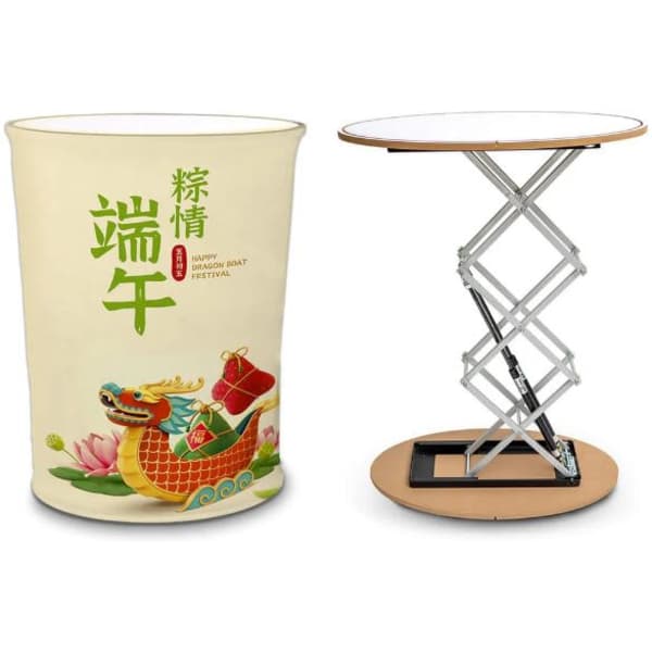 A promotional hydraulic table in a round shape, featuring a white top and a colourful, festive design on the base.