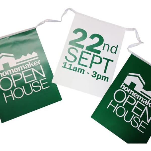 Three green and white rectangular paper bunting flags with text and a logo, featuring the words 