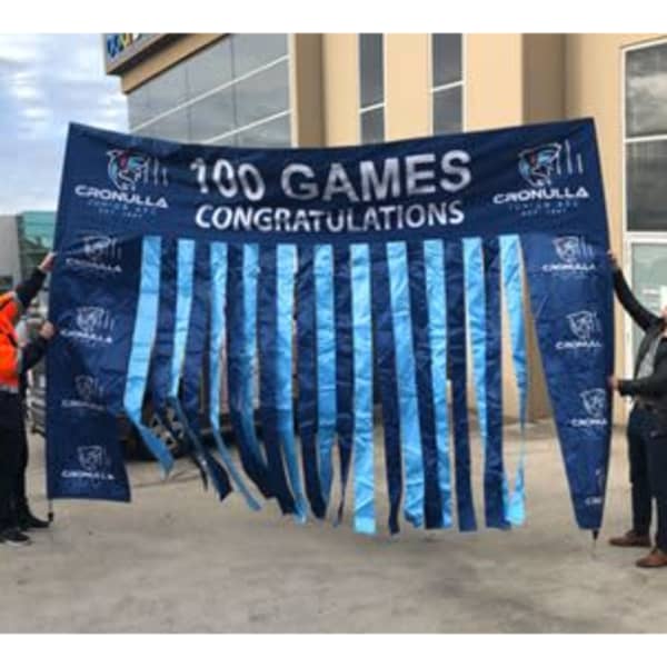 A large blue banner with ribbon elements, featuring text celebrating 