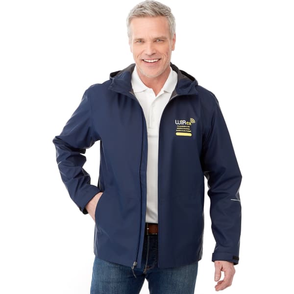 A navy blue men's rain jacket with a hood and a logo. The model is smiling and wearing a polo shirt underneath.