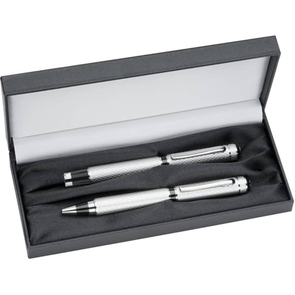 A double pen box featuring two silver pens, resting on a black fabric interior. The box has a sleek grey exterior and includes a logo.