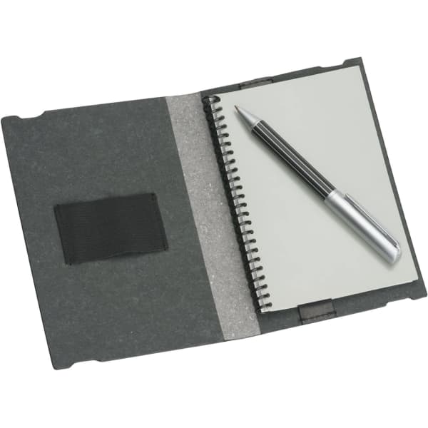 A6 Jotter in charcoal grey featuring a spiral-bound notebook and a silver pen, with an elastic strap on the cover.