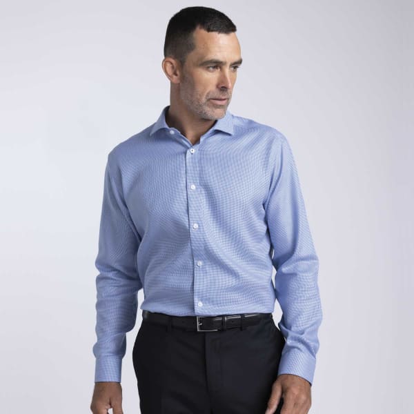 A light blue button-up shirt on a man, featuring a collar and long sleeves, accompanied by a black belt.