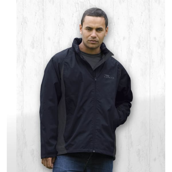 A black Crosswinds Jacket features a zippered front and a logo. The model has hands in pockets against a light background.