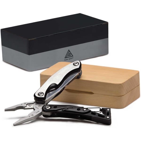 A black and silver multi-tool with pliers, displayed partly open next to a wooden box and a sleek black packaging.