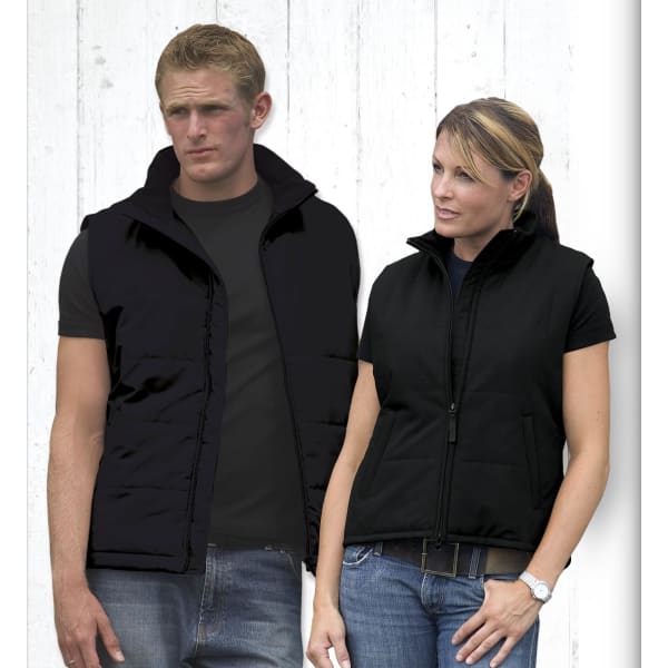 A black men's vest displayed on a male model alongside a black women's vest on a female model. Both have a zippered front and pockets.