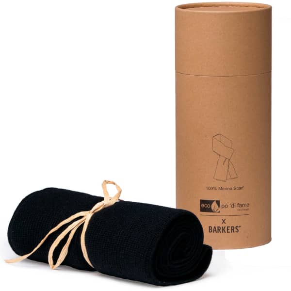 A black 100% Merino scarf tied with string, presented in a cylindrical cardboard packaging with a logo.