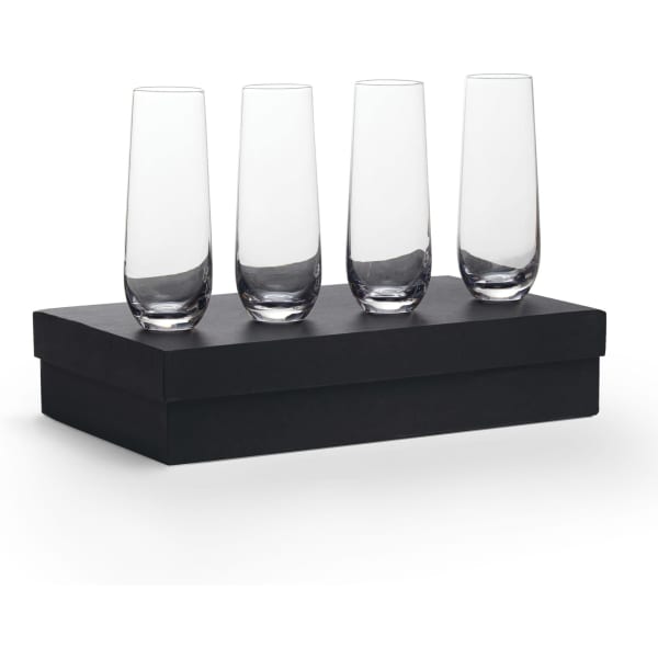 Four clear glass stemless champagne flutes displayed on a black box.