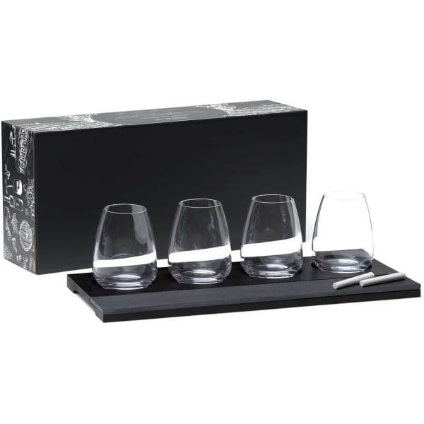 A set of four clear wine glasses on a black tray, accompanied by a chalk marker, all packaged in a decorative box.
