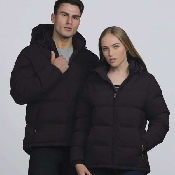 Two models wearing black smpli Edge Puffa Jackets, featuring hoods and a puffer design. The jackets have a logo.