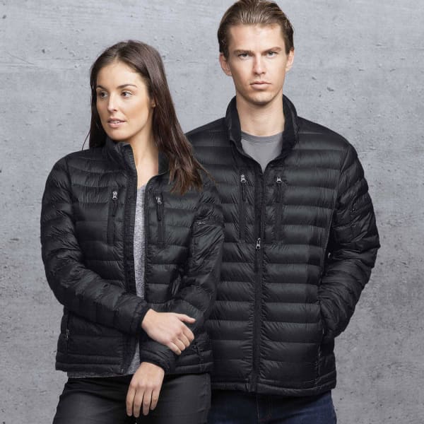 A black puffer jacket displayed on a male and female model against a grey background. The jacket features zippers and a logo.