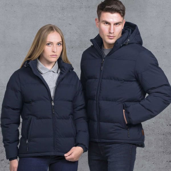 A navy puffer jacket with a hood, featured on a man and woman standing against a grey background.