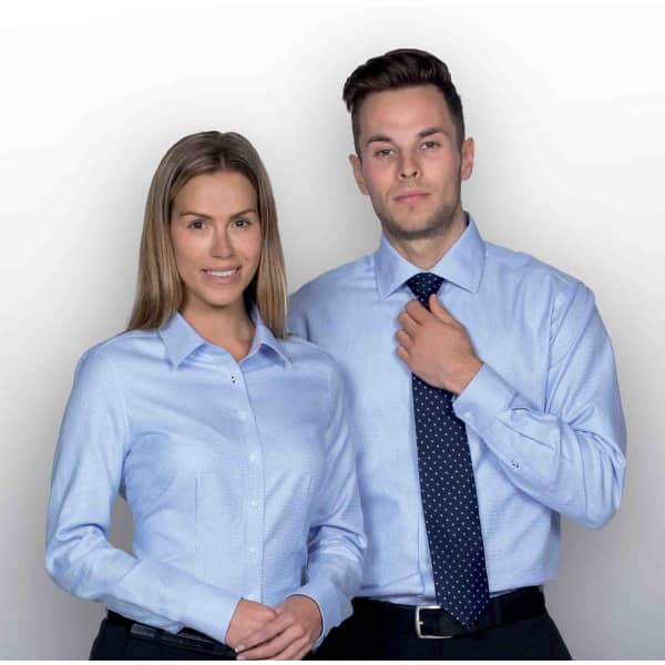 A light blue button-up shirt for men featuring a logo, worn with a patterned tie.
