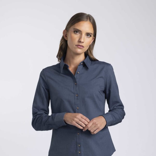 A women's button-up shirt in navy blue, featuring a collar and button detailing, with a subtle logo present.