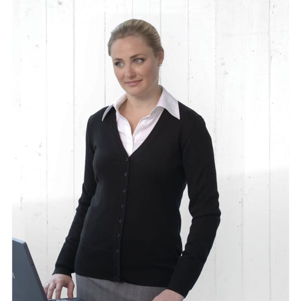 A women's black merino cardigan with a V-neck and button front, paired with a white shirt, displayed against a white backdrop.