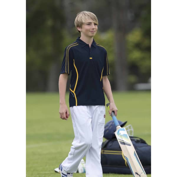 A youth wearing a navy polo shirt with yellow accents, holding a cricket bat, standing on a field.
