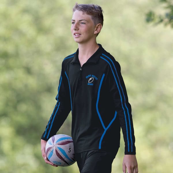 A black zip pullover with blue stripes, featuring a logo, worn by a young person holding a rugby ball outdoors.