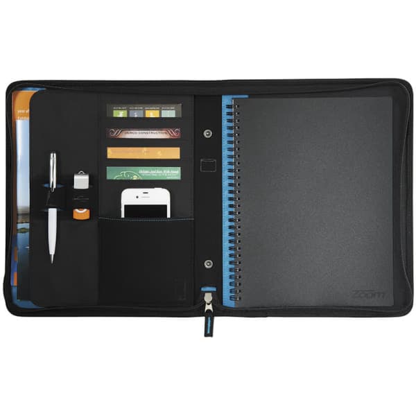A black 2-in-1 tech sleeve journal with a spiral notebook, pen, and pockets for a phone and USB. Features branding.