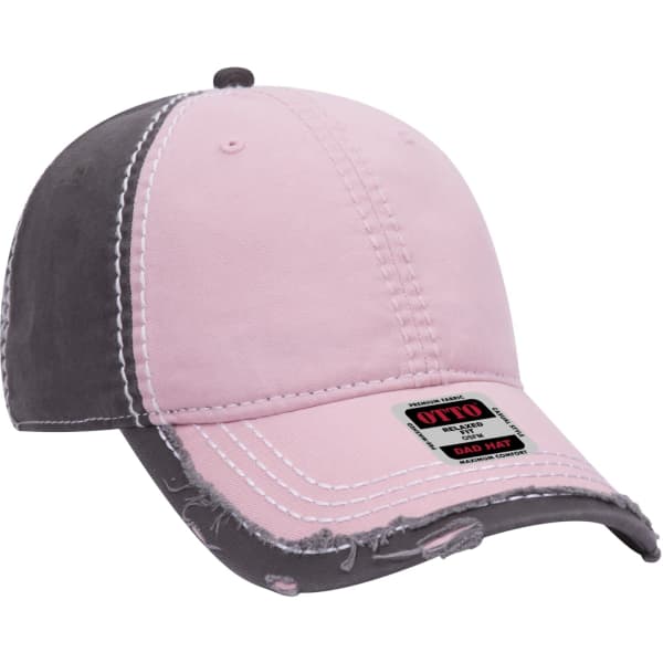 A pink and grey 6-panel dad hat featuring distressed detailing and a logo on the front.