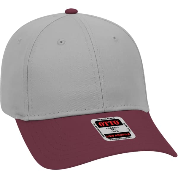 A six-panel baseball cap in grey and maroon, featuring a branding label on the front.