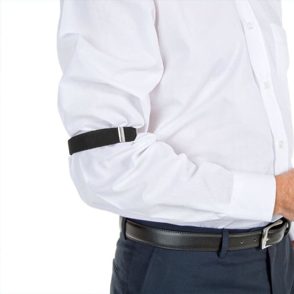 An arm band in black, worn on the upper arm, with a sleek design against a white shirt.