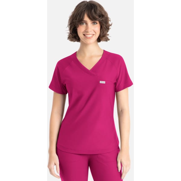 A pink Y-neck top featuring short sleeves and a logo on the chest.