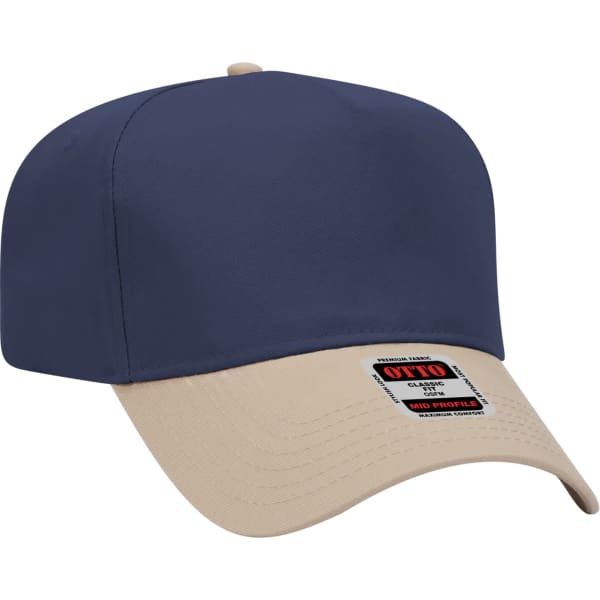 A 5 panel baseball cap featuring a navy blue top and a beige peak, with a logo on the label.