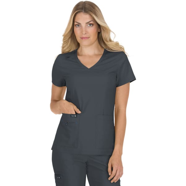 A grey scrubs top with a V-neck, featuring short sleeves and two front pockets, worn by a model.