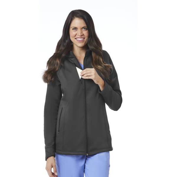 A woman wearing a black fleece jacket with a hood, featuring a zip front and side pockets. The jacket has a logo.