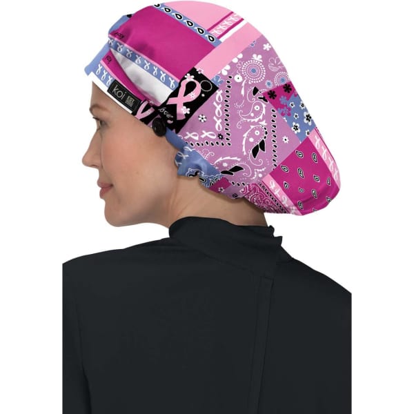 A bouffant scrub cap featuring a vibrant patchwork of pink and purple patterns with a logo.
