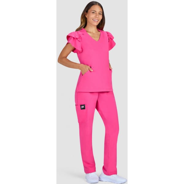 A pink medical scrub set featuring a top with ruffle sleeves and matching trousers, with a logo on the pocket.