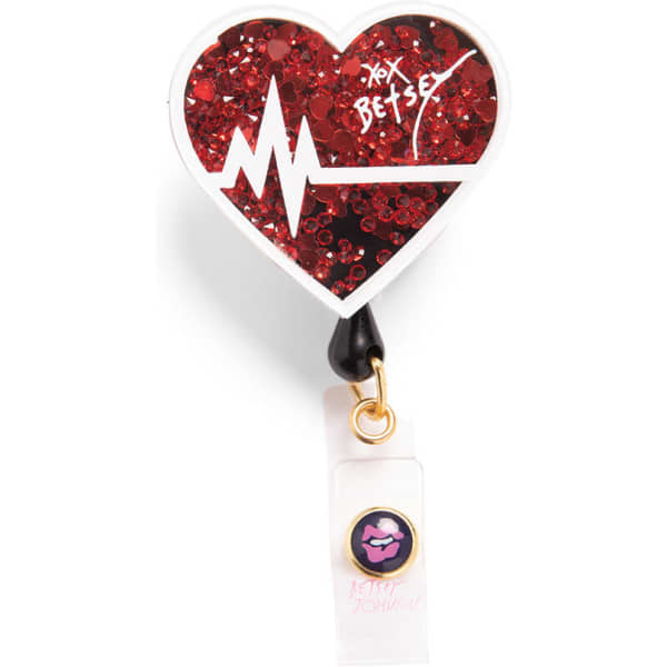 A red heart-shaped retractable badge with glitter and a logo, featuring a heartbeat line and a clip.