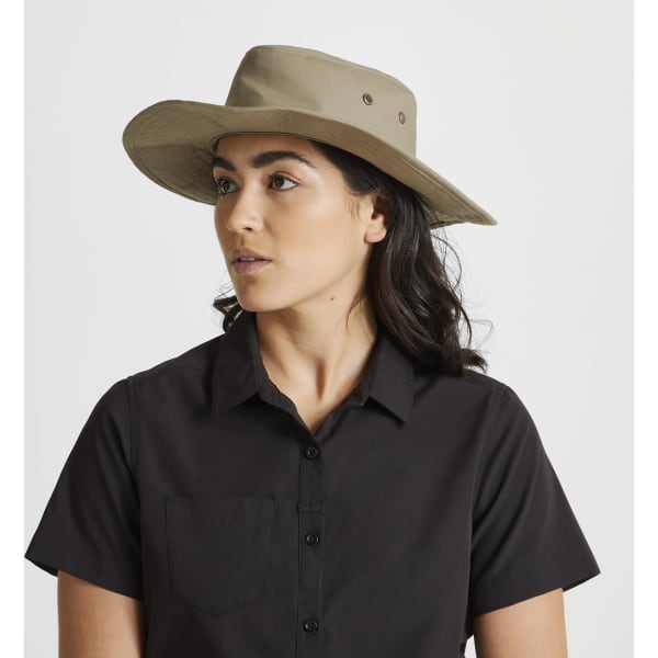 A khaki ranger hat with a wide brim, featuring a logo, worn by a person in a black shirt.