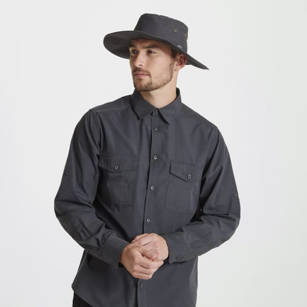 A man wearing a dark grey Kiwi ranger hat and a long-sleeve button-up shirt with pockets. The hat has a simple design.