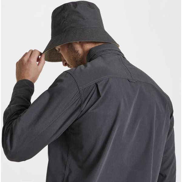 A dark grey reversible sun hat is displayed, featuring a bucket style and a person adjusting it on their head.