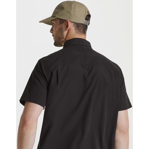 A man wearing a khaki trucker cap and a black short-sleeve shirt, viewed from the back.