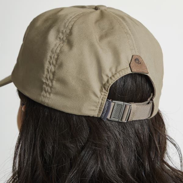 A khaki trucker cap featuring an adjustable strap and a small logo on the back.