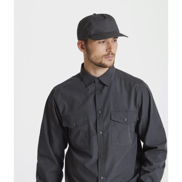 A black trucker cap is worn by a man in a matching black button-up shirt. The cap features a logo.