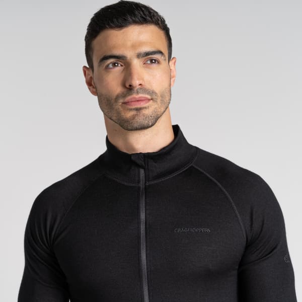 A black Merino half zip long sleeve baselayer top with a fitted design and a logo on the sleeve.