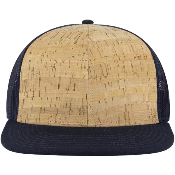 A 6 panel mid-profile trucker cap featuring a textured cork front and navy mesh sides and back. It has a logo.