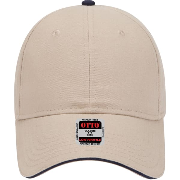 A beige low profile baseball cap featuring a branded label and contrasting navy details on the peak.