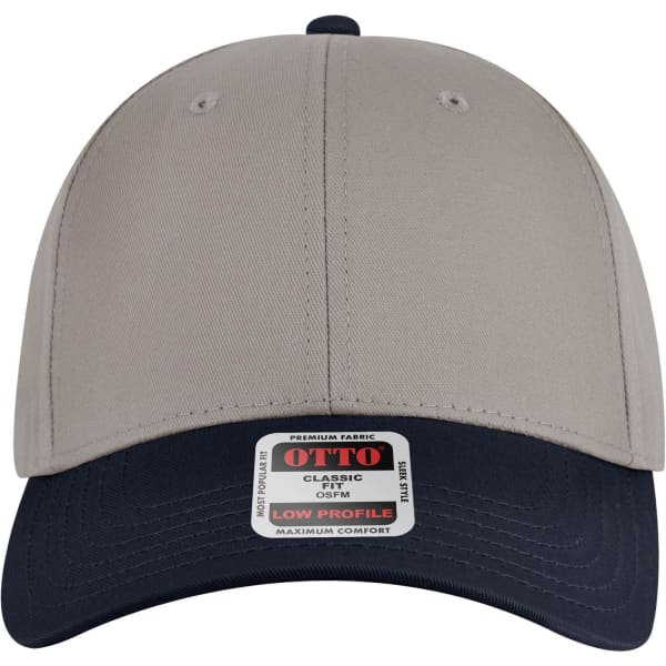 A low profile baseball cap in beige with a navy blue brim, featuring a brand logo on the front.