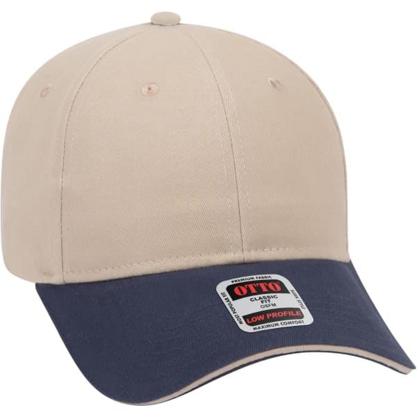 A beige and navy 6 panel low profile baseball cap with a logo tag on the side.