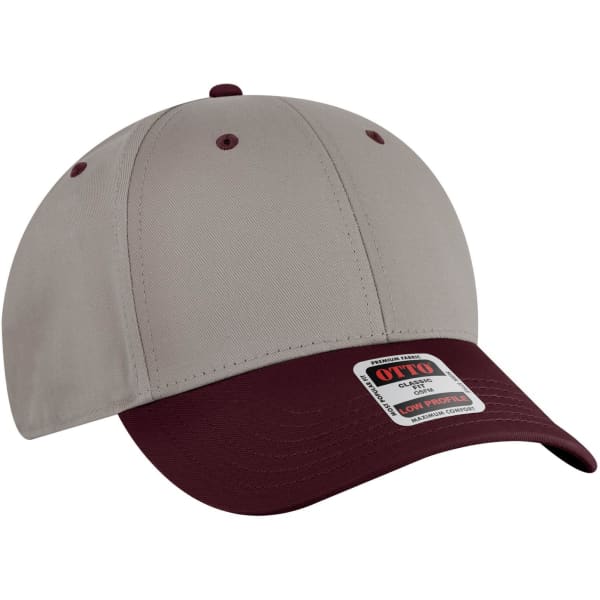 A low profile baseball cap featuring a beige crown and a maroon peak, with a logo on the front.