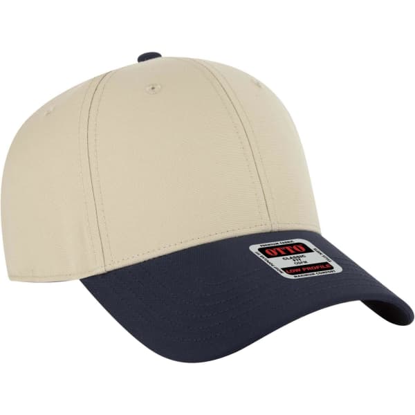 A low profile baseball cap in beige with a navy blue brim, featuring a logo on the front.