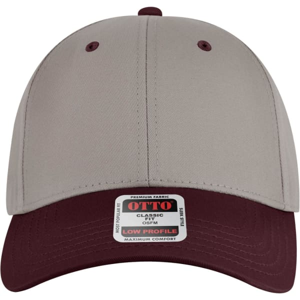 A low profile baseball cap in beige and burgundy with a logo tag on the front.