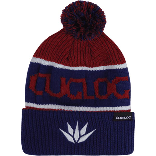 A beanie in red and blue with a pom-pom on top and a logo on the side.