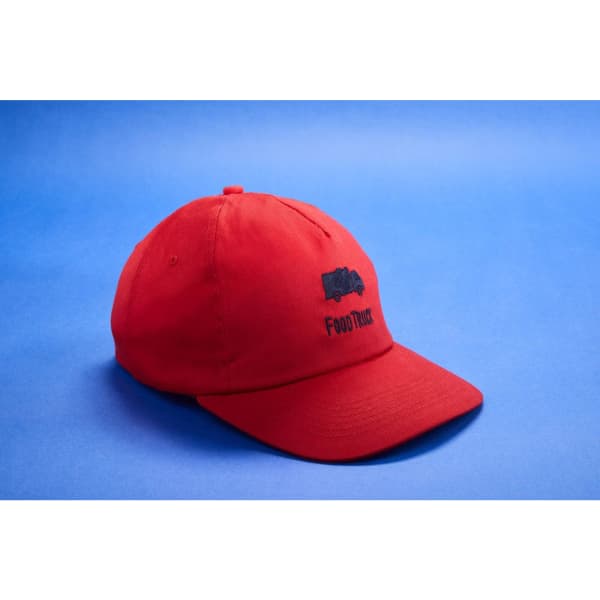 A red 5 panel cap with a curved brim and a logo on the front.