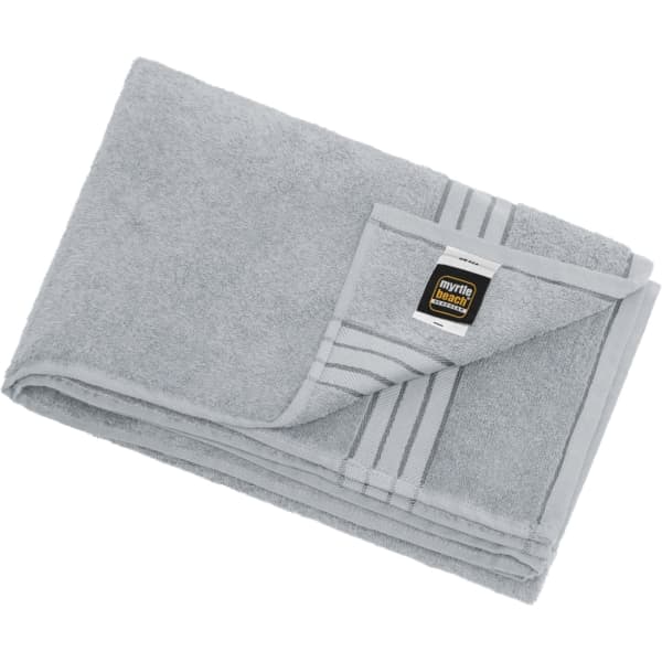 A grey bath sheet featuring a folded design and a logo on the corner. Soft and absorbent fabric.